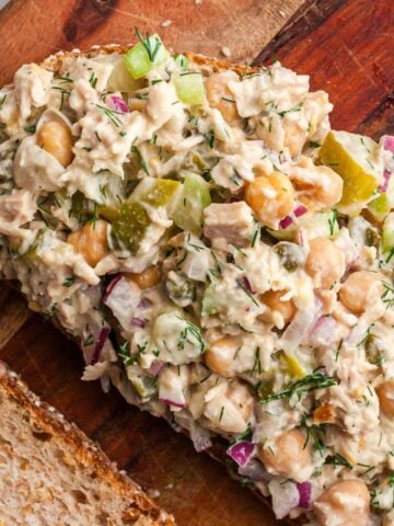 open faced sandwich with tuna and chickpea salad, on cutting board
