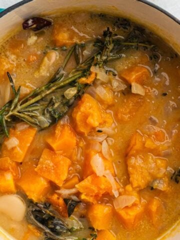 Creamy bean stew with orange squash and fresh herbs.