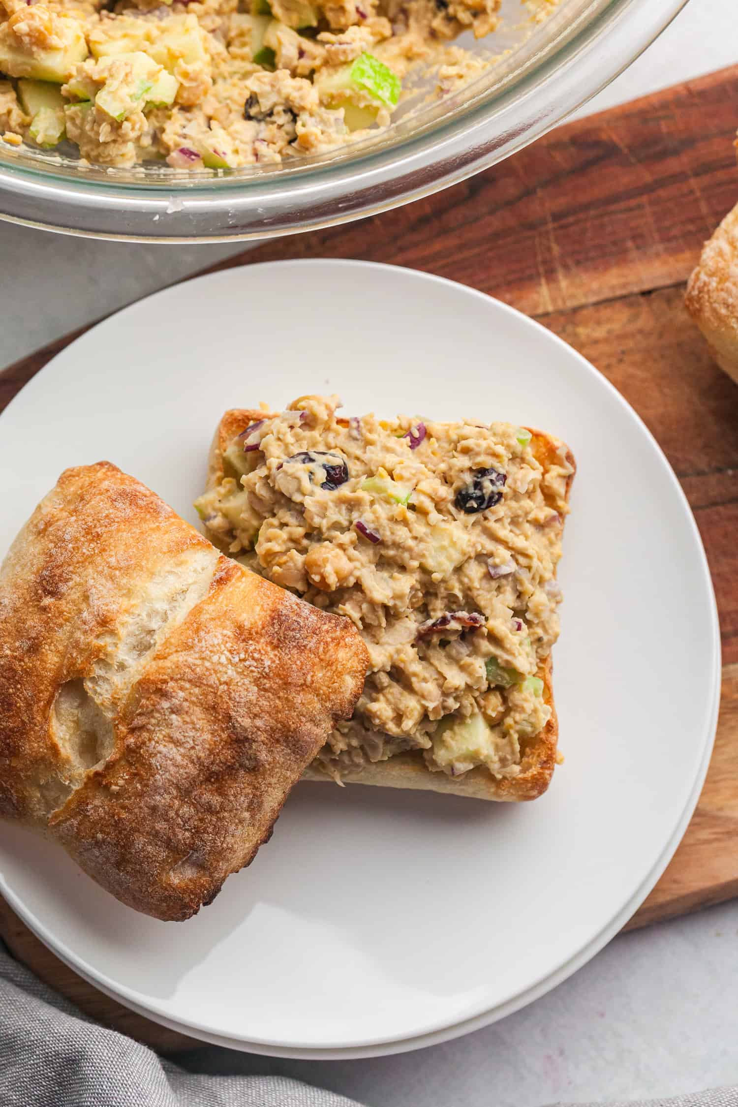 Ciabatta sandwich with chickpea chicken salad—celery, onion, cranberries, and creamy filling.