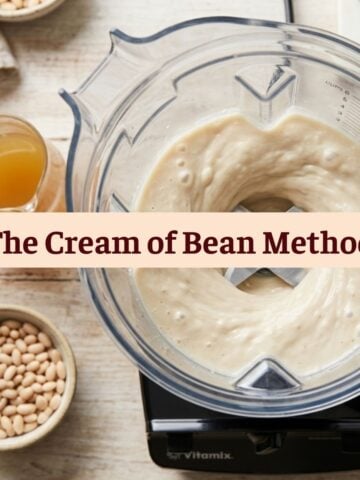 Overhead view of a Vitamix blender swirling a smooth white bean puree for "The Cream of Bean Method," a dairy-free soup thickener.